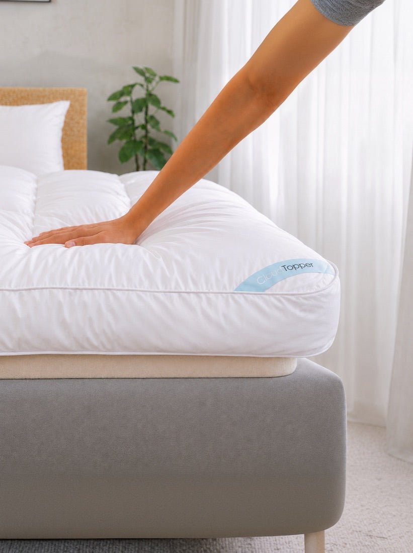 Hand pressing into the CloudTopper mattress topper
