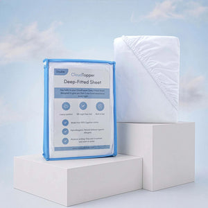 Deep fitted sheet in luxury cotton with CloudTopper packaging on white display blocks