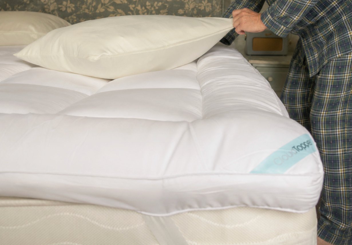 A thick CloudTopper on a made bed