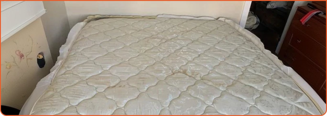 Worn and stained old mattress